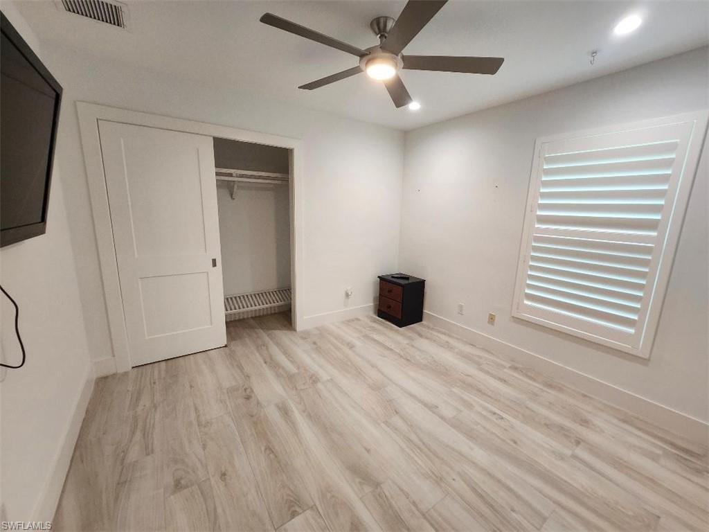 512 Raven Way Naples, FL 34110 - Photo 7 of 20 Unfurnished bedroom with light wood-style flooring, a closet, ceiling fan, and recessed lighting