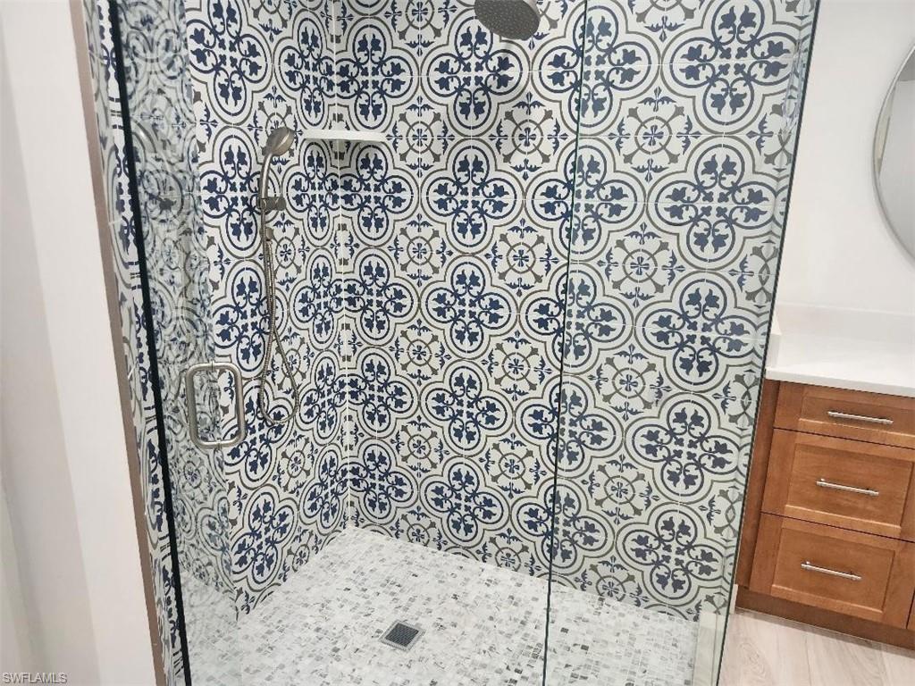 512 Raven Way Naples, FL 34110 - Photo 9 of 20 Full bathroom featuring vanity and walk in shower