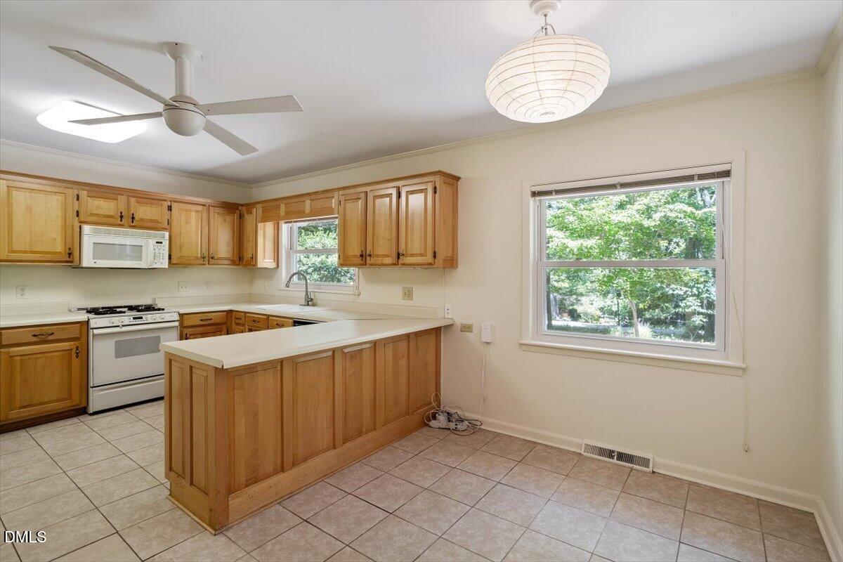 904 Kings Mill Road Chapel Hill, NC 27517 - Photo 6 of 33 a kitchen with a stove sink and a refrigerator