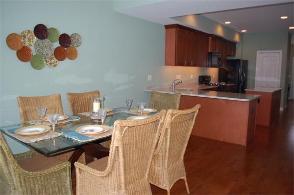 170 Beach Road, Unit MODEL Salisbury, MA 01952 - Photo 4 of 8 a kitchen with a table chairs and a stove