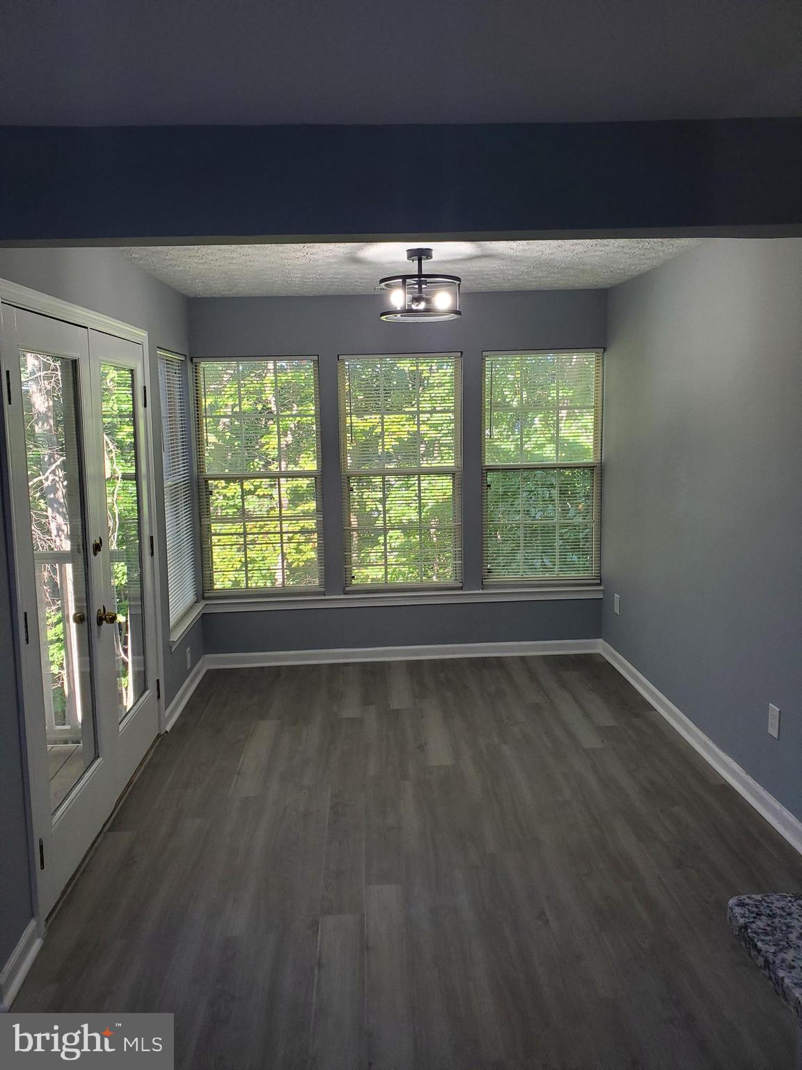 1304 Clover Valley Way, Unit K Edgewood, MD 21040 - Photo 7 of 10 a view of an empty room with wooden floor and a window