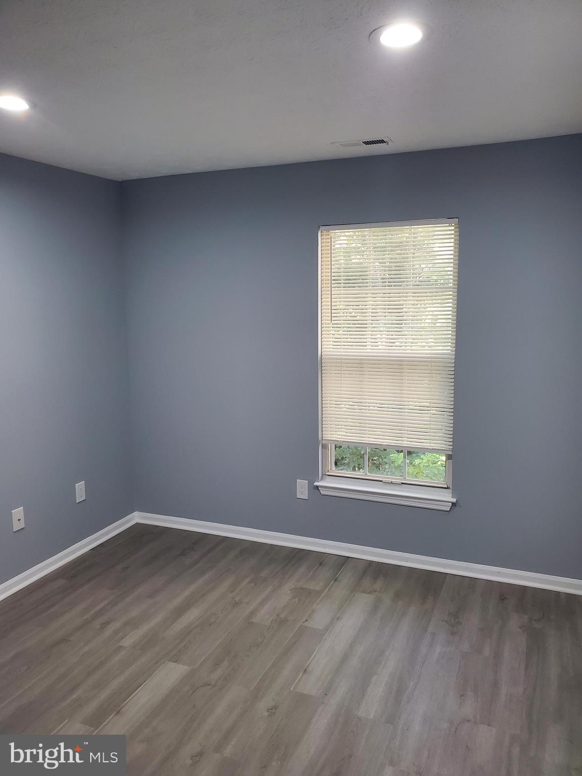1304 Clover Valley Way, Unit K Edgewood, MD 21040 - Photo 10 of 10 an empty room with wooden floor and windows