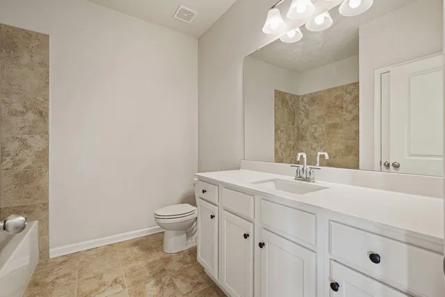 an empty room with chandelier fan and windows