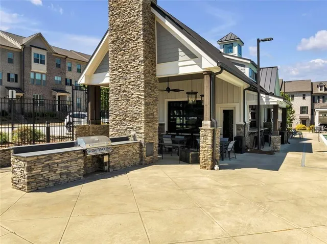 a view of a patio with a table and chairs and potted plants