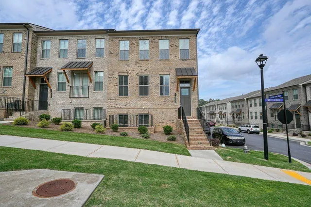a front view of a house with a yard