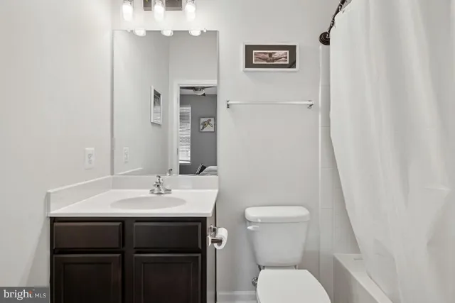 a bathroom with a granite countertop bathtub a sink and a mirror