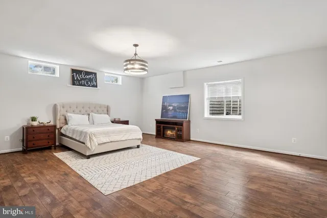 an aerial view of a house with swimming pool garden and trees