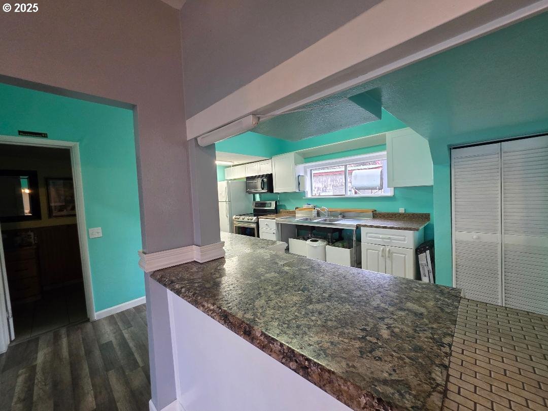 57036 Wamic Market Road Wamic, OR 97063 - Photo 11 of 31 a kitchen with stainless steel appliances granite countertop a sink and cabinets
