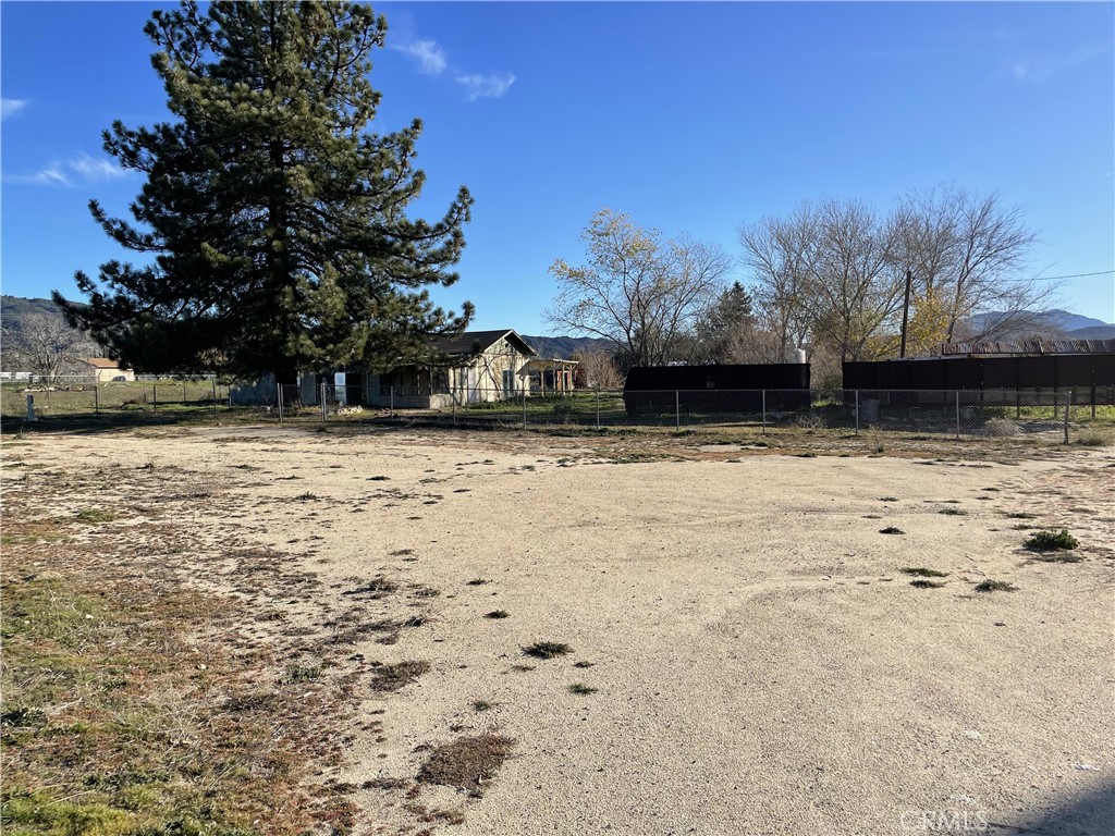 a view of yard covered with snow in front of house