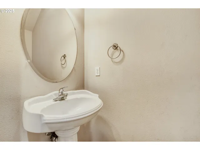 a bathroom with a sink and mirror