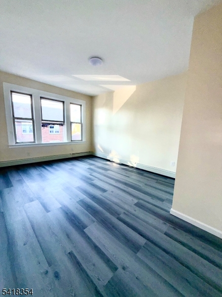 37-39 Field Place, Unit 2R Newark, NJ 07112 - Photo 1 of 10 wooden floor in an empty room with a window