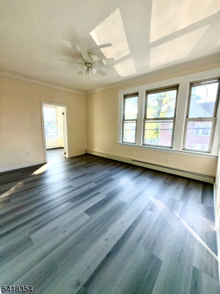 37-39 Field Place, Unit 2R Newark, NJ 07112 - Photo 2 of 10 an empty room with wooden floor and windows