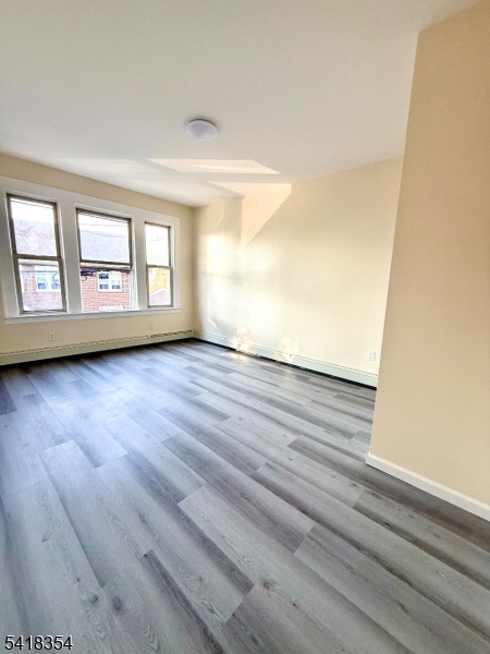 37-39 Field Place, Unit 2R Newark, NJ 07112 - Photo 3 of 10 wooden floor in an empty room with a window