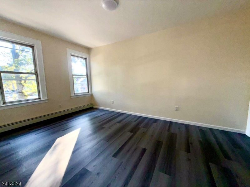 37-39 Field Place, Unit 2R Newark, NJ 07112 - Photo 9 of 10 wooden floor in an empty room with a window