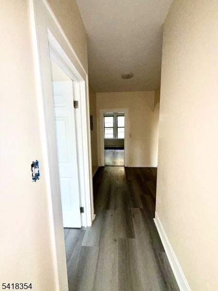 37-39 Field Place, Unit 2R Newark, NJ 07112 - Photo 10 of 10 a view of a hallway with wooden floor and staircase