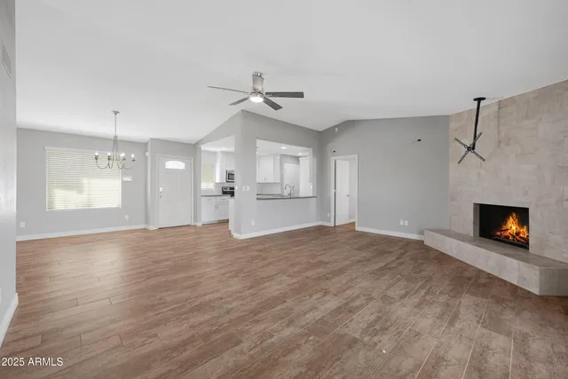 a view of an empty room with a fireplace and a window