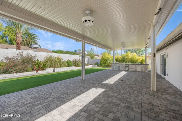 a white bench sitting in front of a building