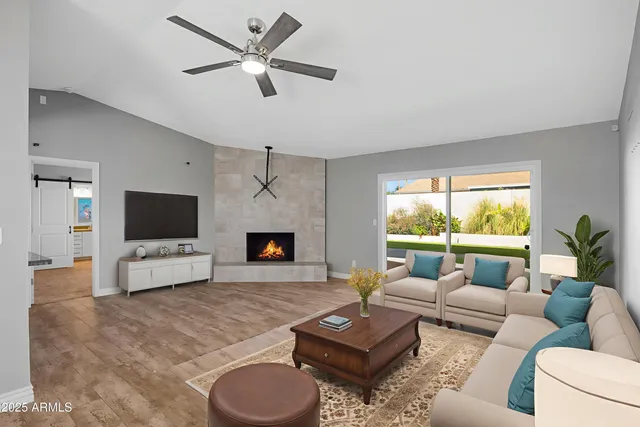 a living room with furniture fireplace and a flat screen tv