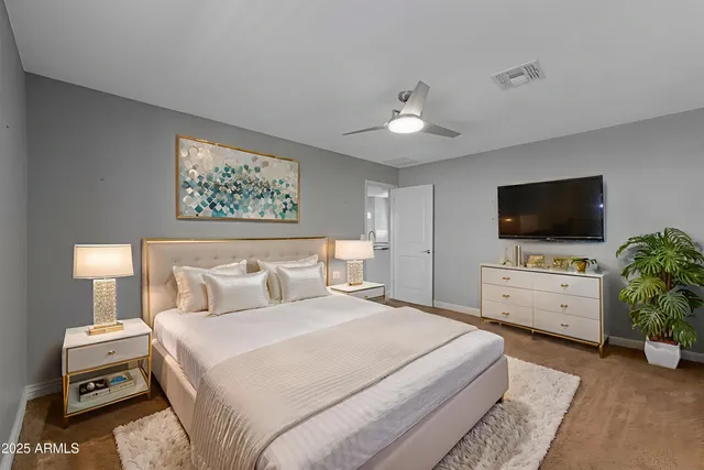 a bedroom with a bed and a flat screen tv