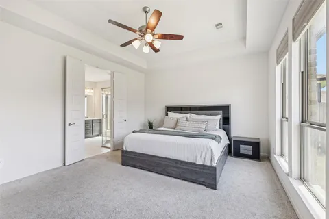 a living room with furniture a flat screen tv and a window