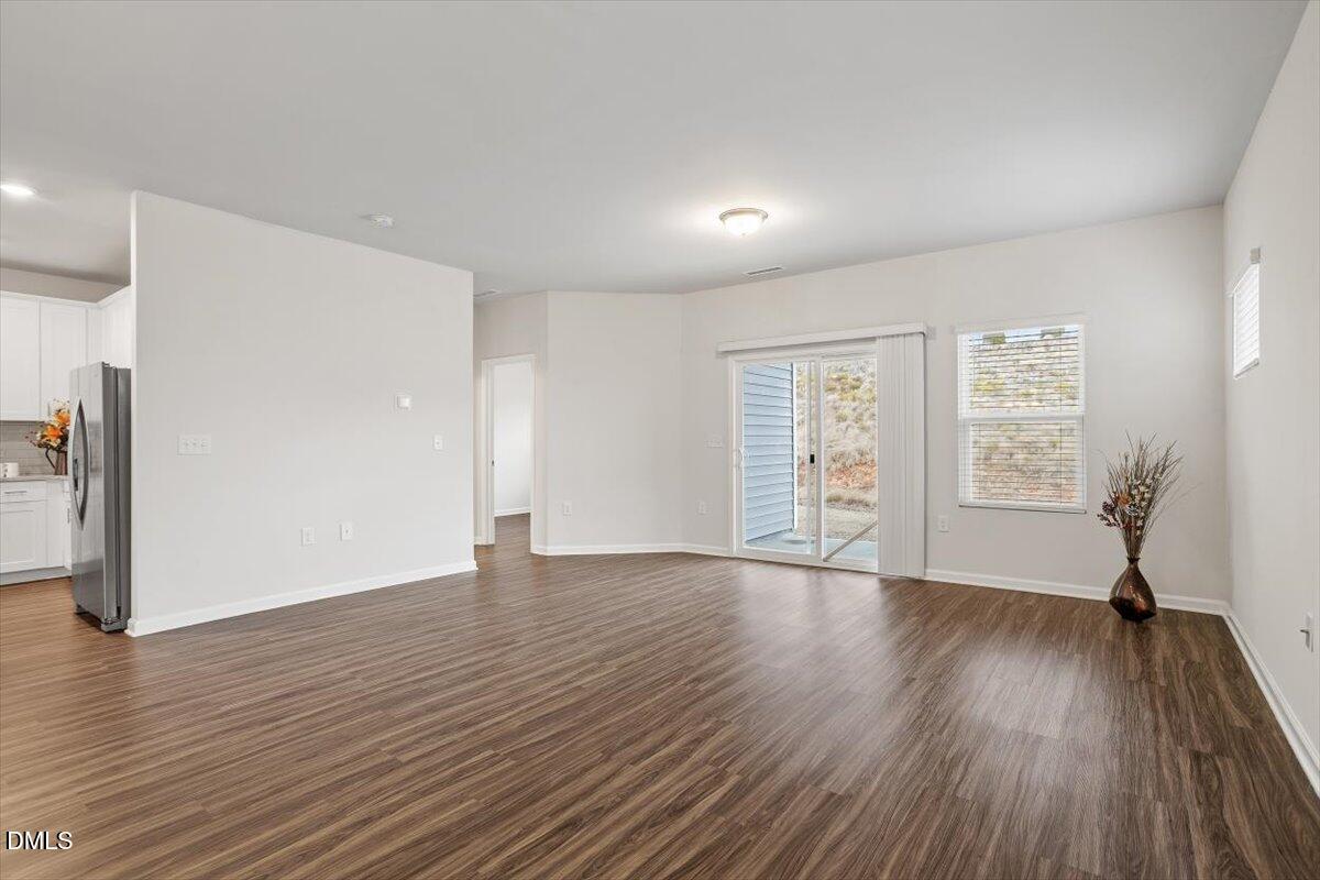 46 Coffee Tree Circle Clayton, NC 27527 - Photo 14 of 36 a view of an empty room with wooden floor and a window