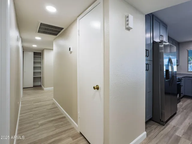 a view of a hallway with a wooden floor