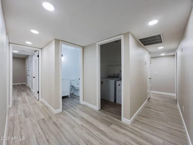 a view of hallway with wooden floor