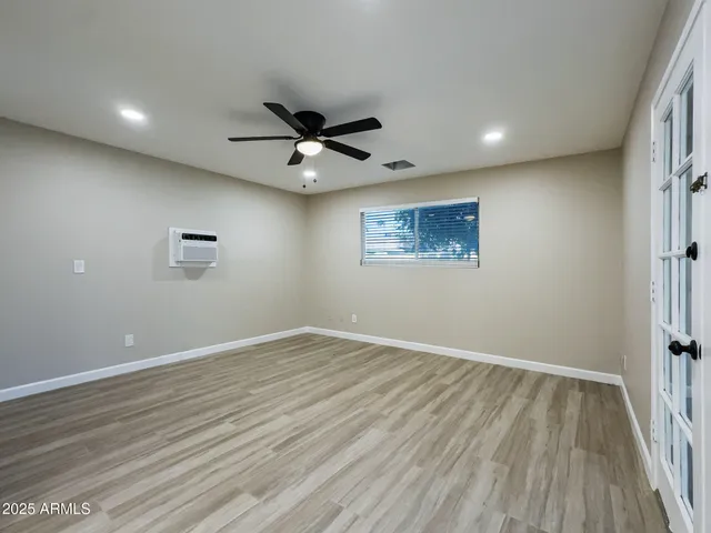 wooden floor in an empty room with a window