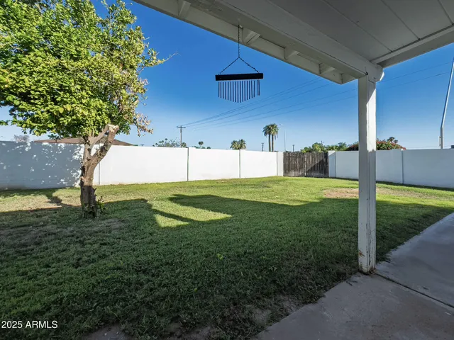 a view of a house with a backyard