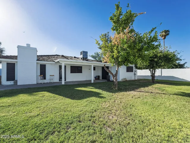 a view of a house with swimming pool and a yard