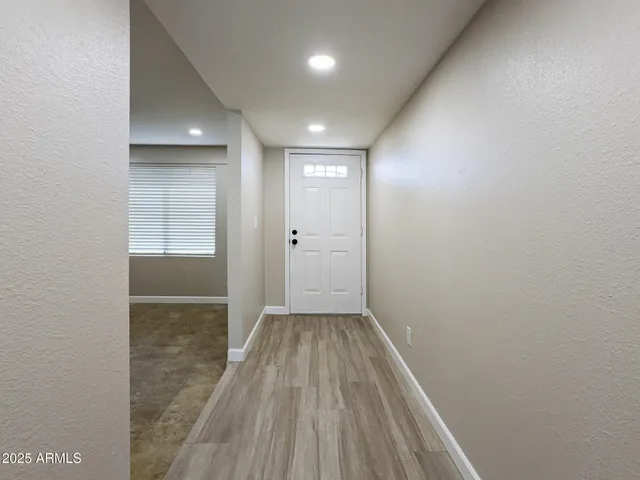 an empty room with closet and wooden floor
