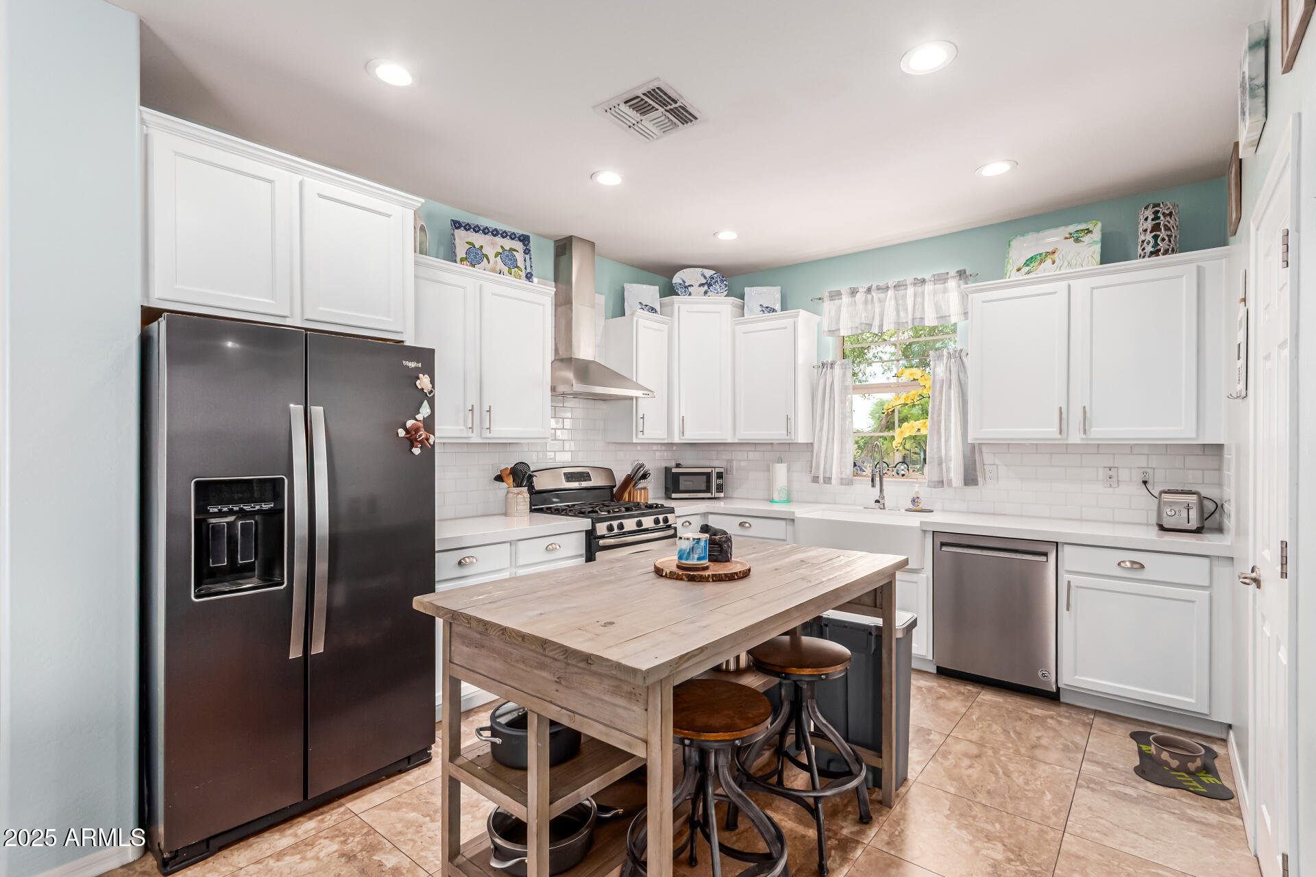 2435 North Riley Road Buckeye, AZ 85396 - Photo 3 of 30 a kitchen with a center island appliances and cabinets
