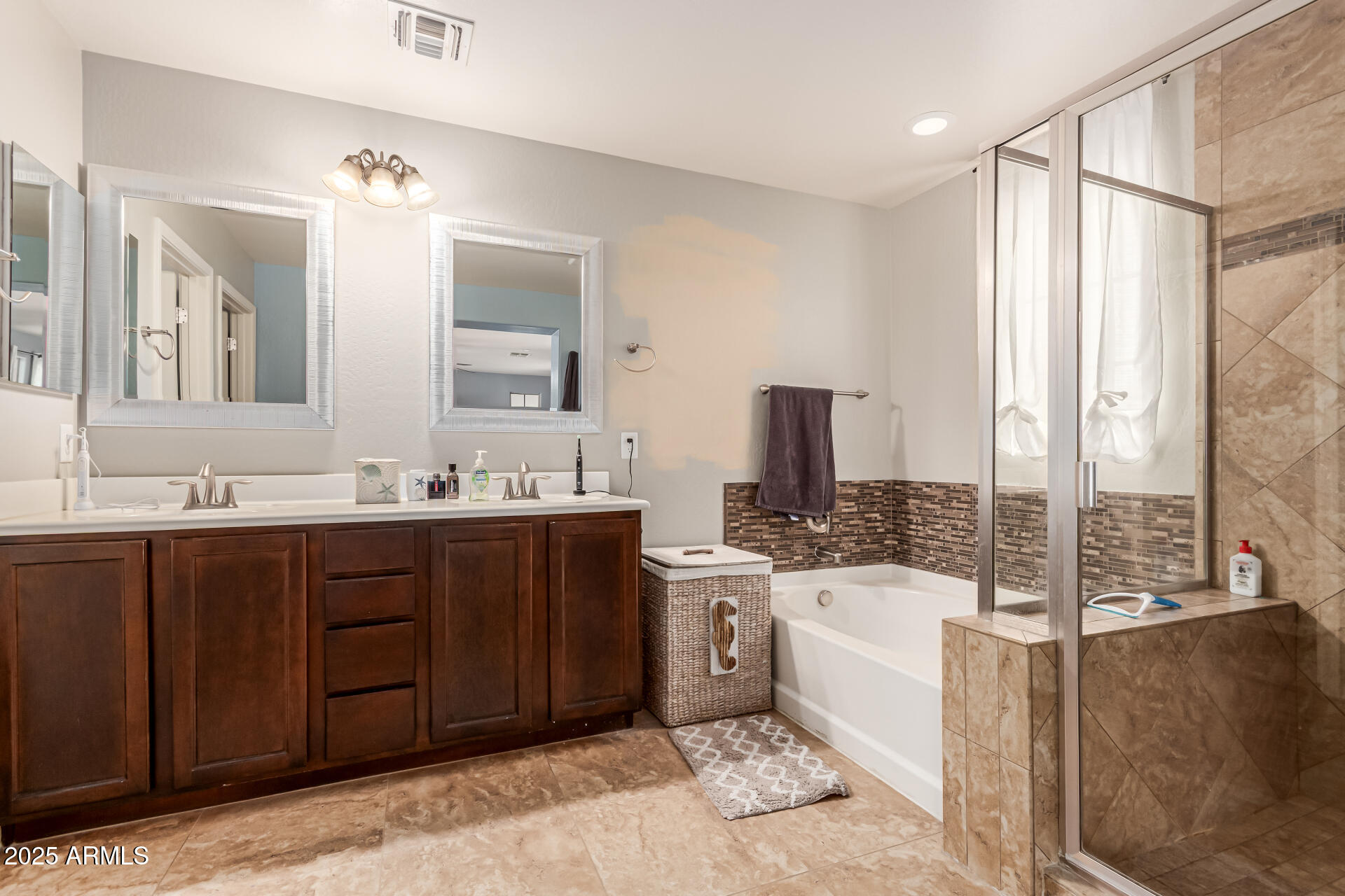 2435 North Riley Road Buckeye, AZ 85396 - Photo 7 of 30 a spacious bathroom with a tub sink and mirror