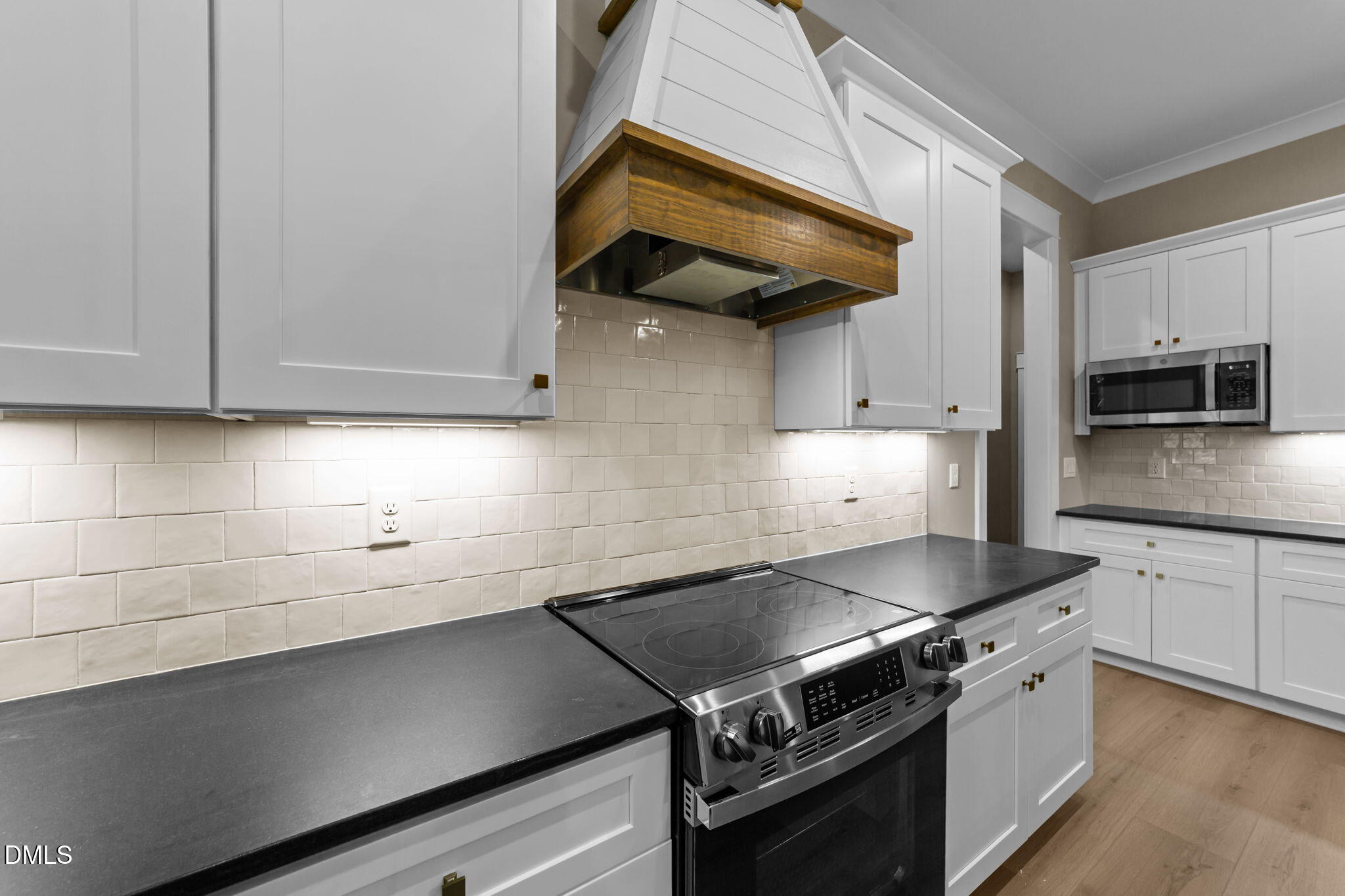 2590 Lassiter Road Four Oaks, NC 27524 - Photo 21 of 72 a kitchen with stainless steel appliances granite countertop a sink a stove and cabinets
