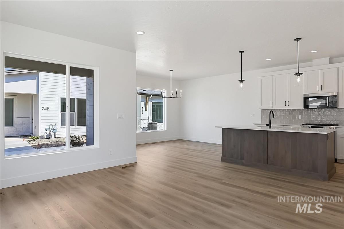 776 South Calhoun Lane Star, ID 83669 - Photo 20 of 49 Open-concept living space featuring wood-finish flooring, white walls, and recessed lighting