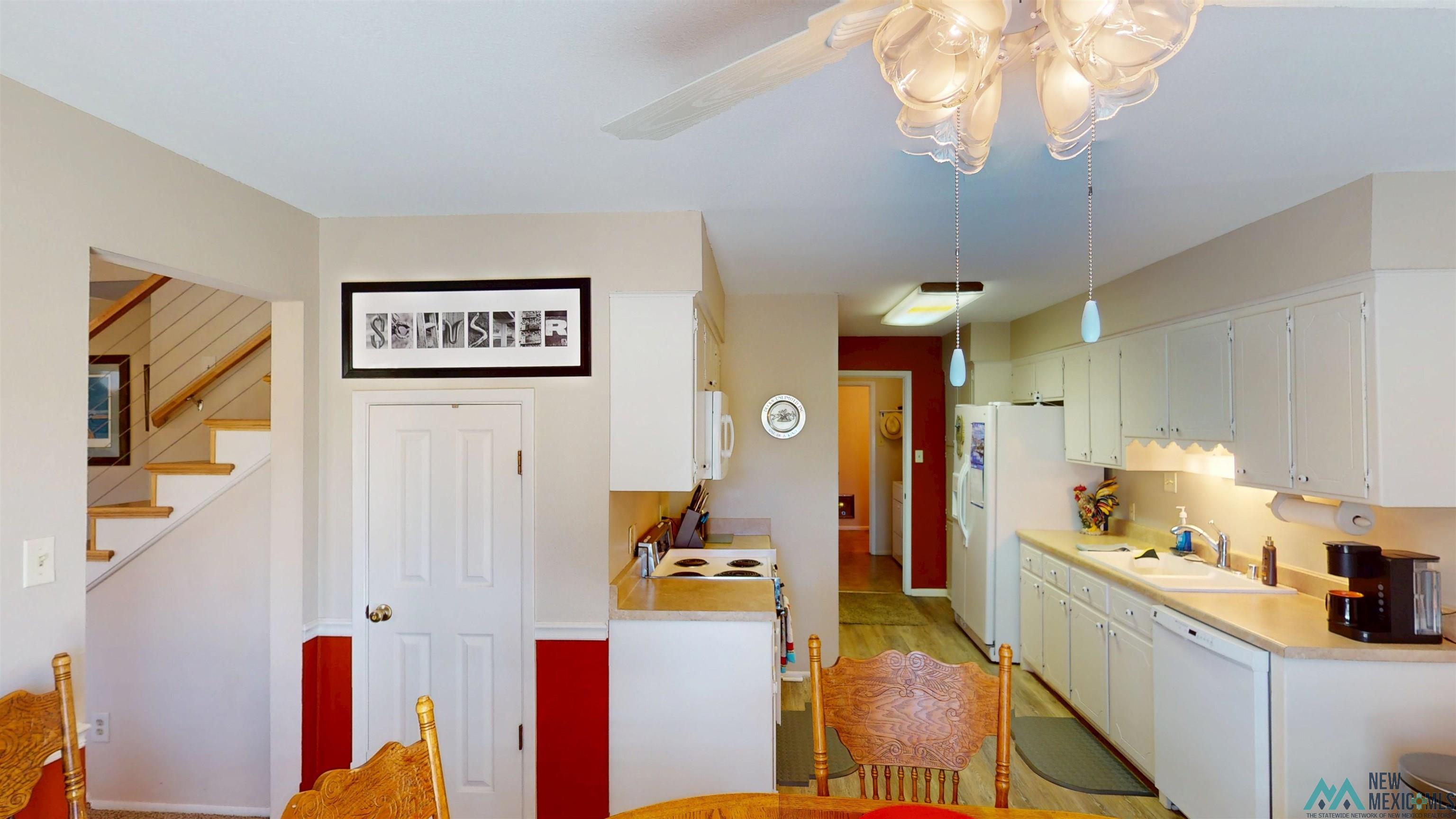 23 Pendaries Lane Rociada, NM 87742 - Photo 6 of 26 Kitchen featuring white cabinetry, light countertops, and wood-finish flooring