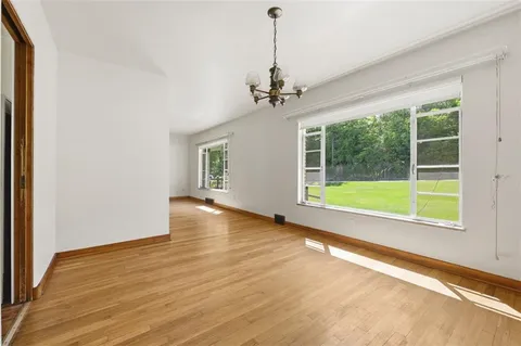a view of a room with wooden floor and windows