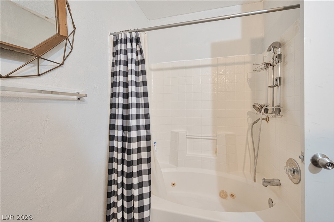 8025 West Russell Road, Unit 1090 Las Vegas, NV 89113 - Photo 17 of 23 Tiled walls and a deep soaking tub create a functional bathing space.