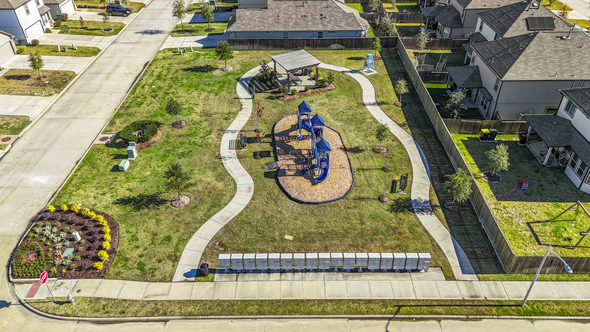 3571 Cannon Drive Conroe, TX 77301 - Photo 34 of 39 Neighborhood park with a modern playground, pathways, and landscaped areas. It's surrounded by residential homes, providing a family-friendly environment ideal for outdoor activities and community gatherings.