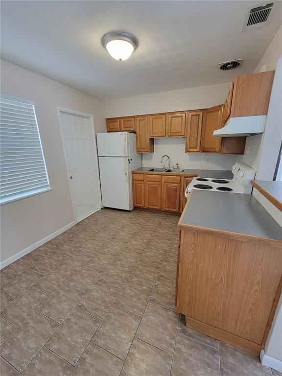 250 37th Street North St. Petersburg, FL 33713 - Photo 11 of 16 a kitchen with a stove and a refrigerator