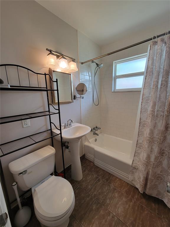 250 37th Street North St. Petersburg, FL 33713 - Photo 8 of 16 a white toilet sitting next to a bath tub and shower