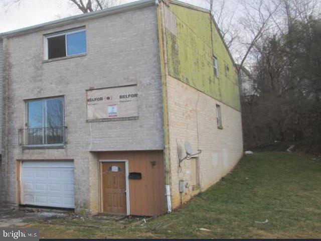 a view of a brick house with a small yard
