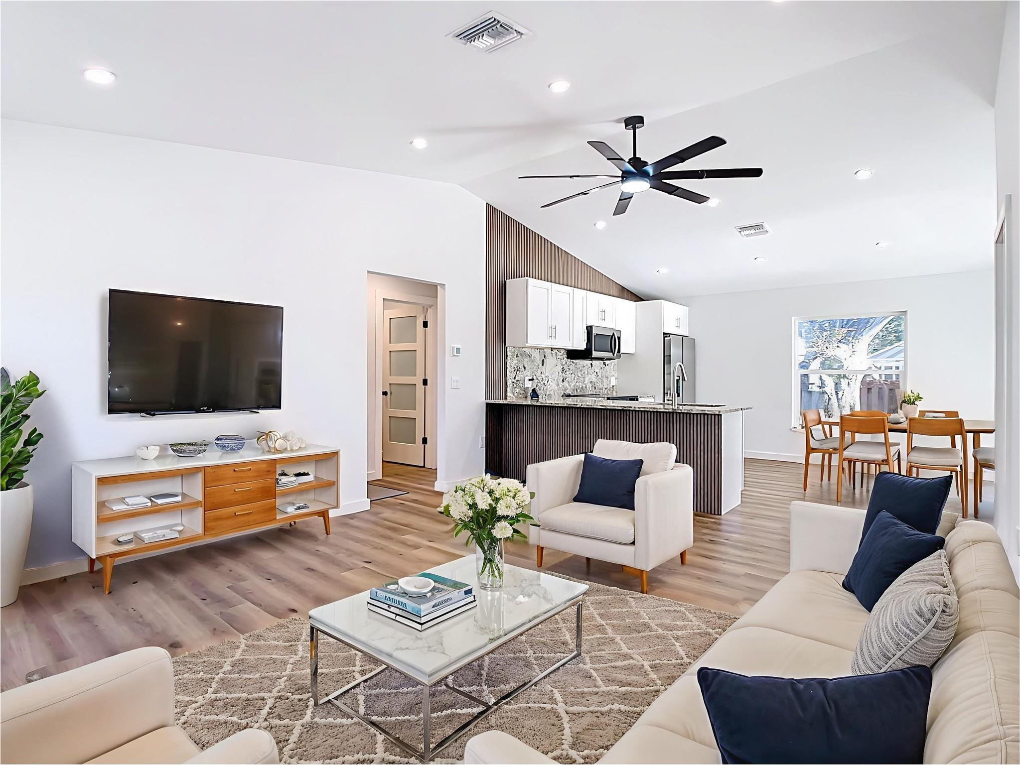 2565 Englewood Road Venice, FL 34293 - Photo 2 of 19 a living room with furniture and a flat screen tv