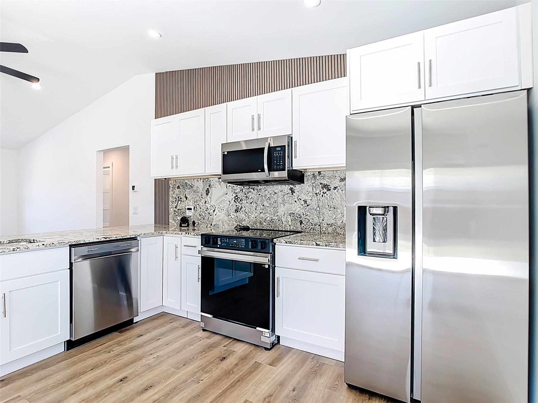 2565 Englewood Road Venice, FL 34293 - Photo 3 of 19 a kitchen with a refrigerator stove and microwave