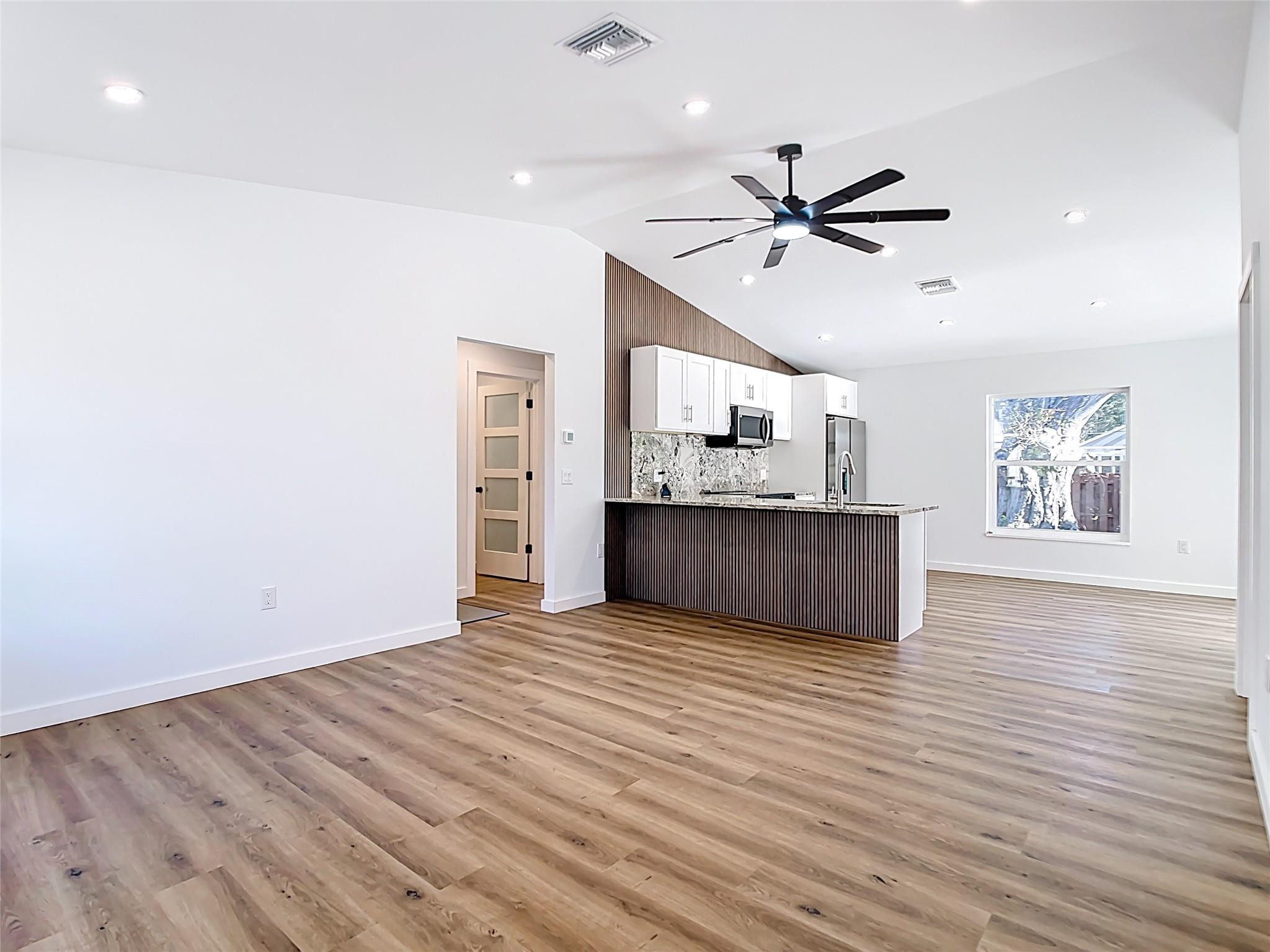 2565 Englewood Road Venice, FL 34293 - Photo 5 of 19 a view of a kitchen with microwave and a ceiling fan