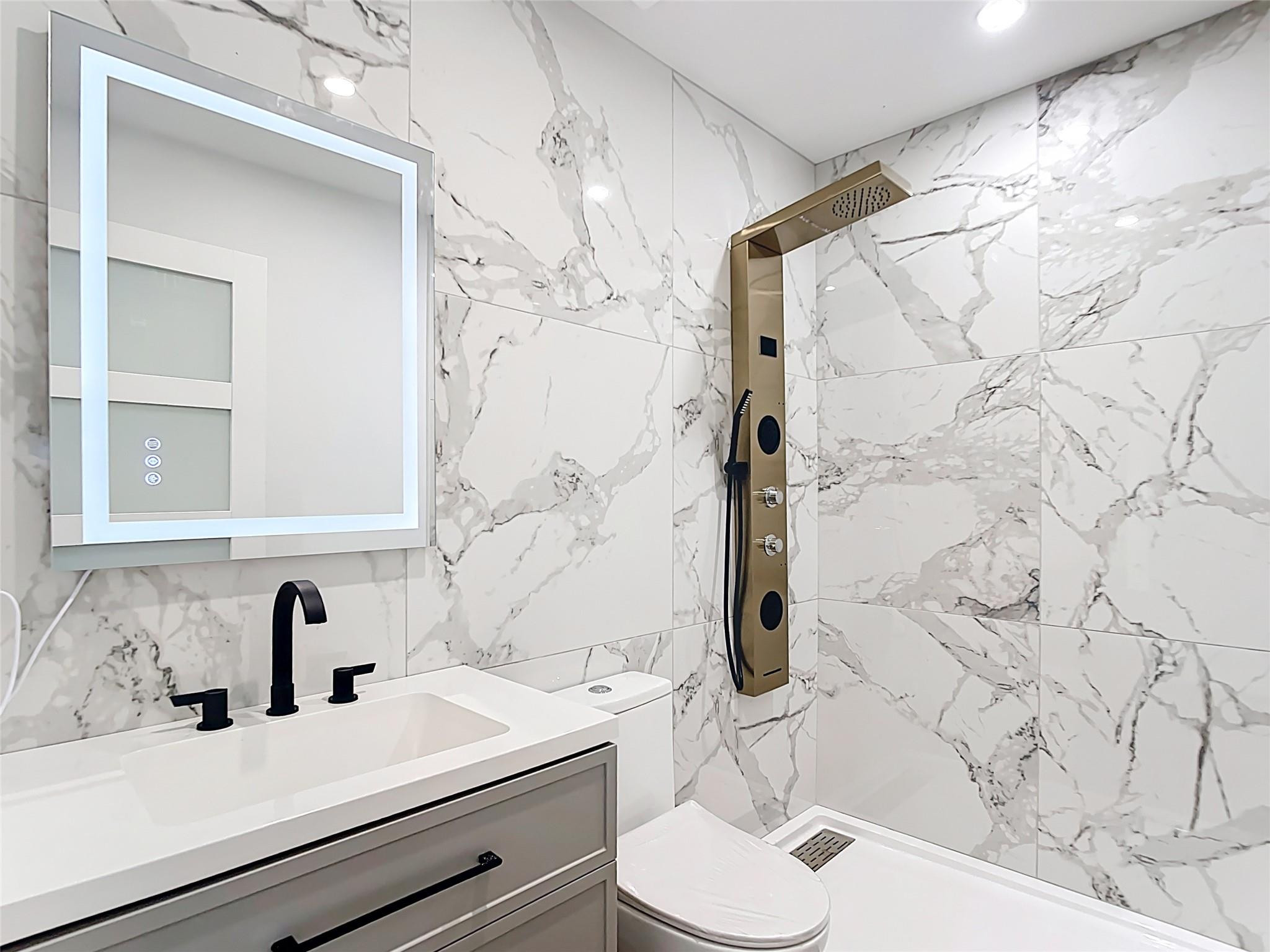 2565 Englewood Road Venice, FL 34293 - Photo 8 of 19 a bathroom with a sink toilet and shower