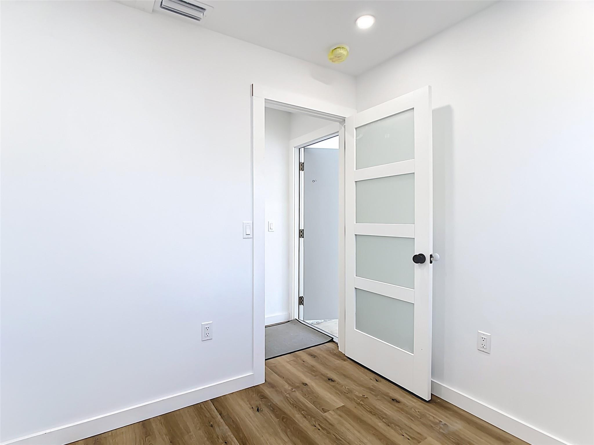 2565 Englewood Road Venice, FL 34293 - Photo 9 of 19 a view of a hallway with wooden floor