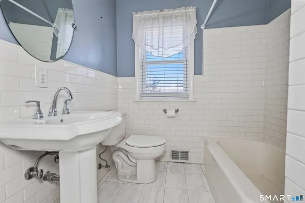 a bathroom with a sink a toilet and bathtub