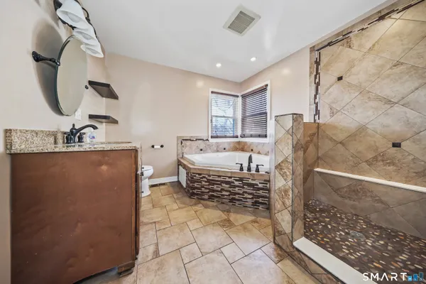 a bathroom with a tub a sink and a shower