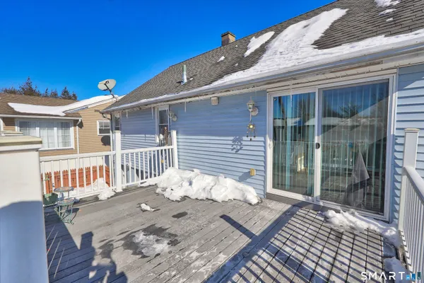 a front view of a house with a yard covered in snow